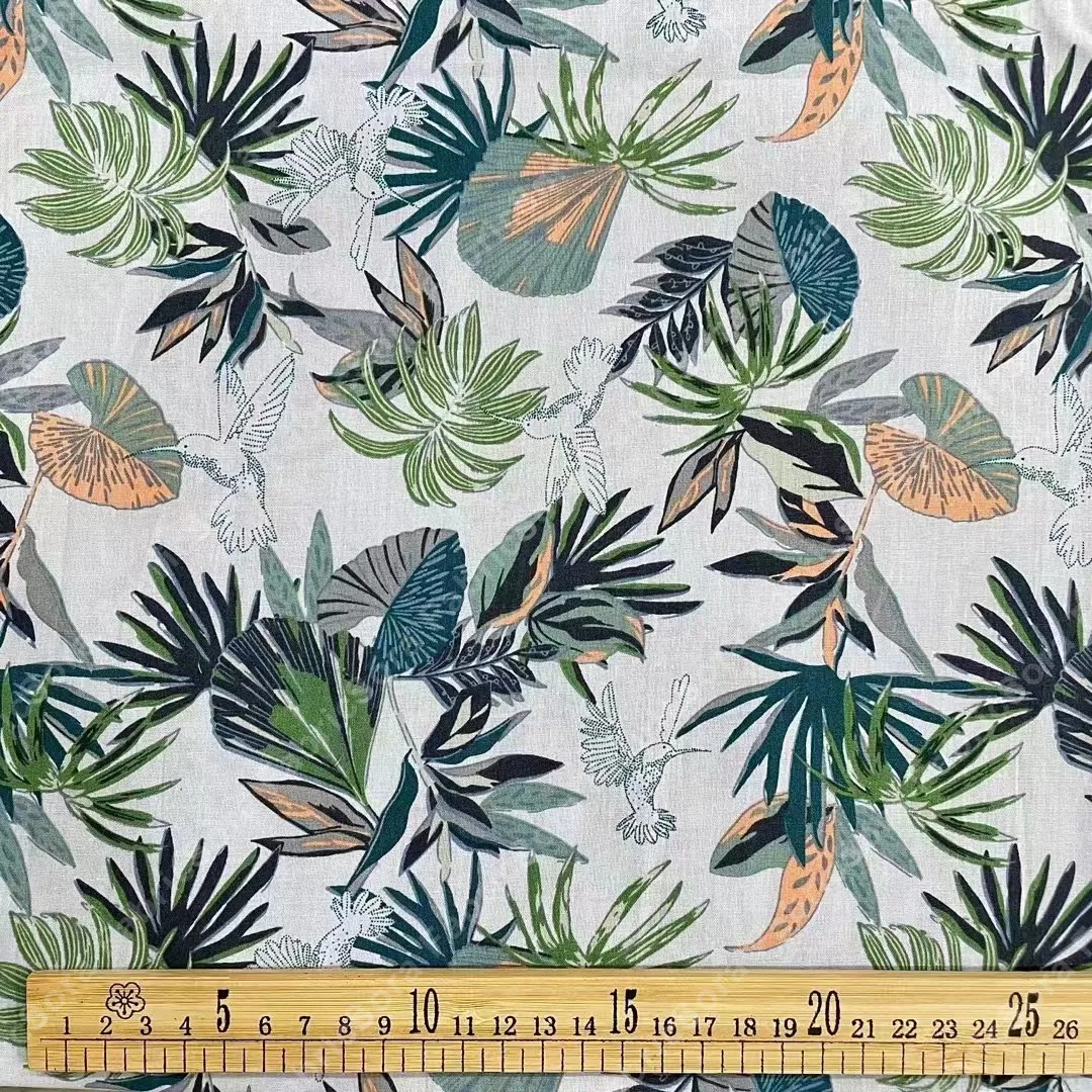 Tropical leaves and birds cotton poplin fabric with palm motifs