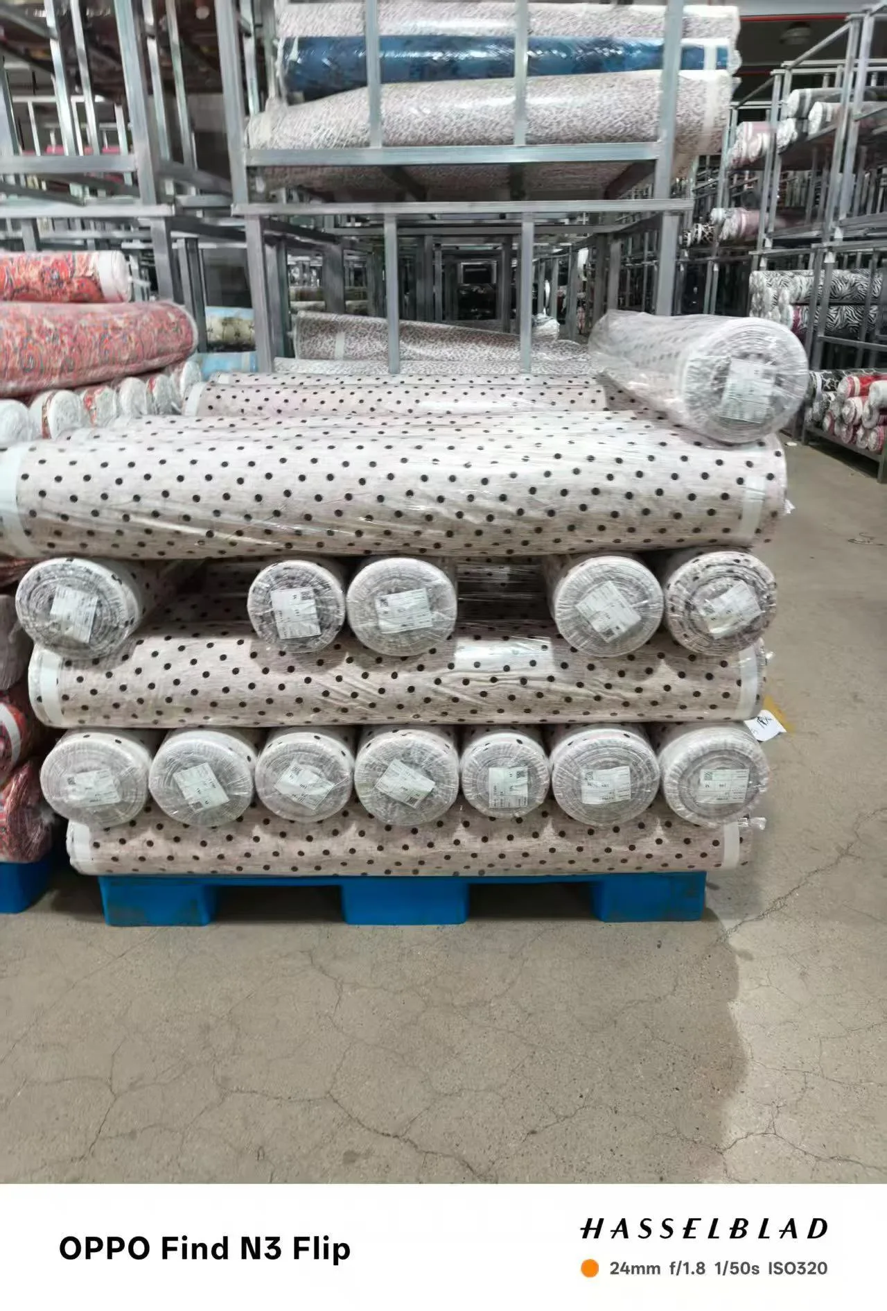 Range of printed cellulose-fiber rolls — rayon, lyocell-blend, and tencel-linen — side by side at Sora Fabrics warehouse