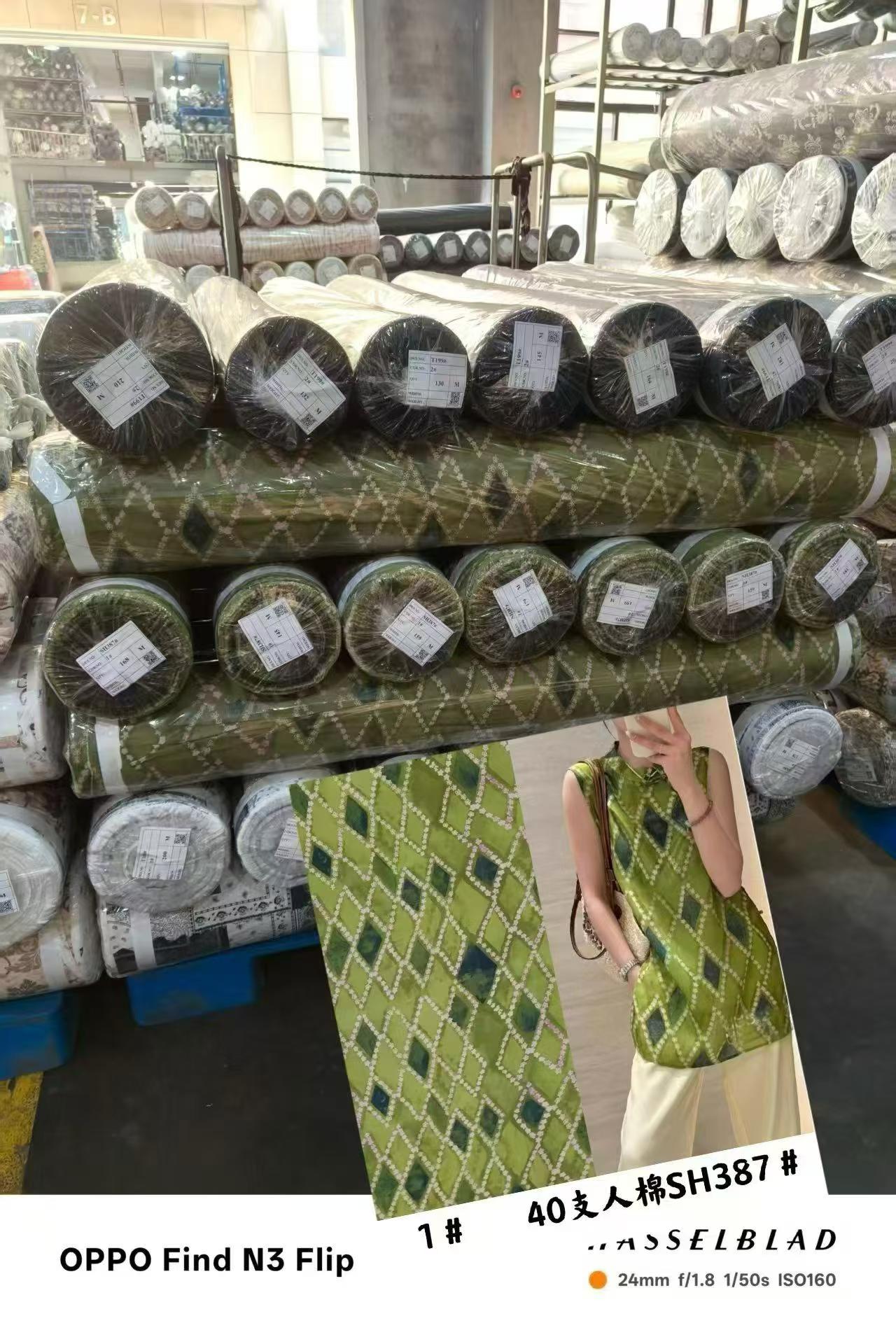 Stacked rolls of printed rayon (viscose) fabric on the warehouse floor at Sora Fabrics