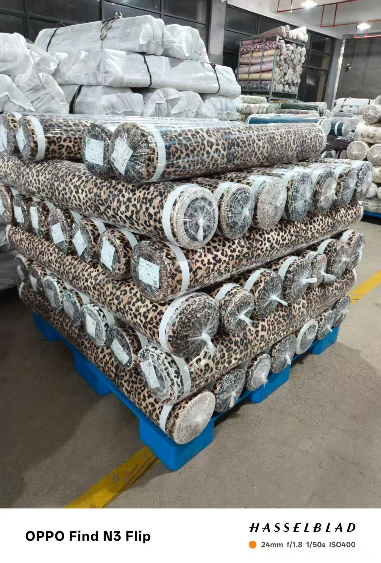 Stacked rolls of printed rayon and cotton fabric ready to ship at low MOQ from Sora Fabrics mill